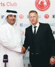  ??  ?? Sheikh Khalifa bin Hamad al-Thani (L), President of the Al Arabi Club, poses with Icelandic football coach Heimir Hallgrimss­on after a press conference in Doha yesterday.