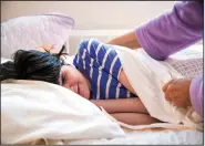  ?? ?? Lisa Haynes, a direct support worker, pulls the covers over Lauren Roesky, who has cerebral palsy and is nonverbal, on Sept. 17 as she lies down in a specialize­d bed that requires power to operate.