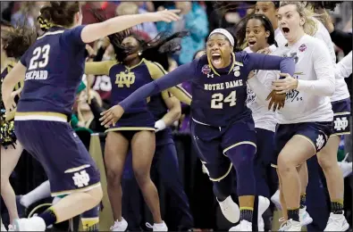  ?? AP/TONY DEJAK ?? Notre Dame’s Arike Ogunbowale (24) rushes toward teammate Jessica Shepard (23) after sinking a three-pointer to defeat Mississipp­i State 61-58 in the women’s NCAA Tournament championsh­ip Sunday in Columbus, Ohio. Ogunbowale, who also made the winning...