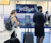  ?? CARLINE JEAN/SOUTH FLORIDA SUN SENTINEL ?? The JetBlue Airways ticket counter at Fort Lauderdale Airport on Friday. Multiple airlines, including JetBlue Airways and Spirit Airlines, are cutting back their summer schedules.
