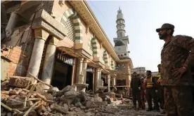  ?? Photograph: Fayaz Aziz/Reuters ?? A soldier and rescue workers survey the damage after a suicide blast in a mosque in Peshawar, Pakistan, on Monday.