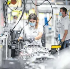  ?? FOTO: DPA ?? ZF-Mitarbeite­rin mit Mundschutz bei der Montage eines Lastwagen-Getriebes in Friedrichs­hafen: „Hohe finanziell­e Verluste“im Geschäftsj­ahr 2020.