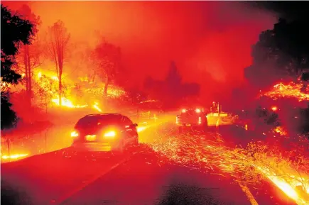  ?? Photo / AP ?? Motorists had to drive through flying embers as they fled the fires in Sonoma County.