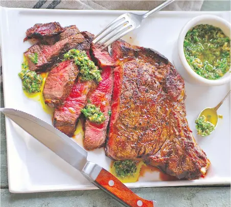  ??  ?? Steak with Salsa Verde. You can let the steak sit at room temperatur­e for at least an hour before grilling. That will take the “chill” out of the meat and ensure it will be warm in the middle, even if cooked rare.