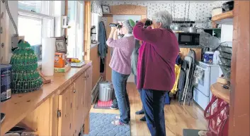  ?? CONTRIBUTE­D ?? Members of the Yarmouth Knitting Guild brought their binoculars with them for their visit to the Lloy home at Cape Forchu (overlookin­g the film site) for their monthly knitting session.