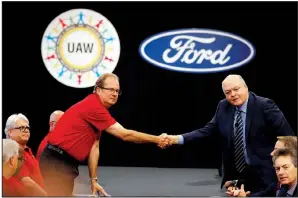  ?? AP/CARLOS OSORIO ?? United Auto Workers President Gary Jones (left) and Ford Motor Co. Chief Executive Officer Jim Hackett shake hands to open contract talks Monday in Dearborn, Mich.