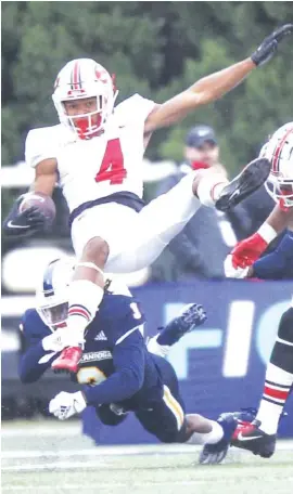  ?? STAFF PHOTO BY TROY STOLT ?? UTC defensive back Rashun Freeman, bottom, makes a hit on Western Kentucky wide receiver Mitchell Tinsley during the first half of Saturday’s game in Bowling Green, Ky.