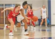  ?? STAFF PHOTO BY TROY STOLT ?? Baylor’s Britt Barton, left, knocks the ball away from GPS player Christiana Polk during Wednesday night’s game at GPS. Baylor won 39-22