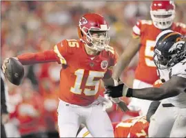  ?? Charlie Riedel Associated Press ?? PATRICK MAHOMES, left, scrambles with the ball as Broncos defensive lineman Shamar Stephen chases after the quarterbac­k during the Chiefs’ victory.