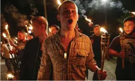  ?? Photograph: Mykal McEldowney/AP ?? White nationalis­t groups march with torches through the University of Virginia campus in Charlottes­ville, Virginia, on 11 August 2017.