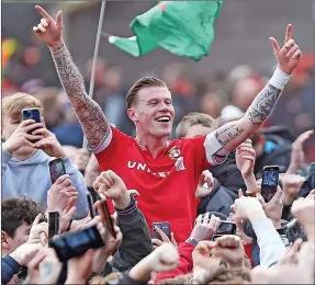  ?? ?? POPULAR: James McClean celebratin­g Wrexham’s promotion with supporters