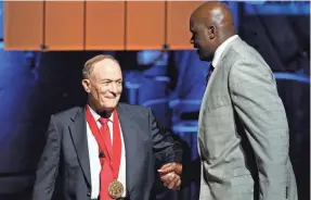  ?? COLIN E. BRALEY/AP ?? Former LSU basketball coach Dale Brown, left, greets former Tigers great Shaquille O’Neal in 2014.