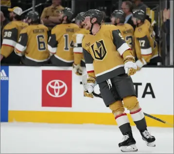  ?? PHOTOS BY JOHN LOCHER — THE ASSOCIATED PRESS ?? Vegas Golden Knights center Jack Eichel celebrates after scoring against the Ducks during the first period of Saturday's game in Las Vegas. The game was the season opener for the Ducks.