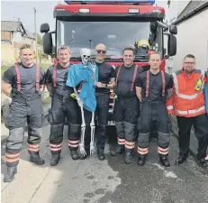  ?? ?? A crew from Cambridges­hire Fire and Rescue Service, who helped encourage the ducks down the river.