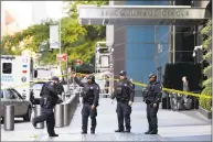  ?? Richard Drew / Associated Press ?? New York City police officers outside the Time Warner Center on Wednesday.