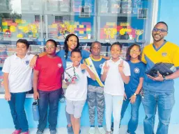  ?? ?? St Hugh’s Preparator­y students and their robotics coaches Diandra Sukhu and Marc Whyte celebrate a day of competitio­n at the World Robot Olympiad Jamaica Semi-finals on September 30, 2023.