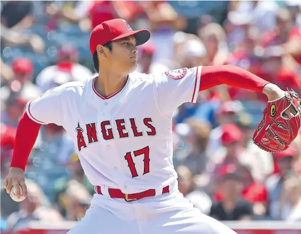 ?? — GETTY IMAGES FILES ?? Shohei Ohtani of the Los Angeles Angels is doing things on the mound and at bat that no one has seen for 100 years. In the first few weeks of the Major League Baseball season, he is undefeated as a starting pitcher and has hit three home runs.
