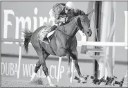  ?? AP/MARTIN DOKOUPIL ?? rides Thunder Snow across the wire to win the $10 million Dubai World Cup in Dubai, the United Arab Emirates, on Saturday.