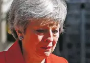  ?? ALASTAIR GRANT/ASSOCIATED PRESS ?? British Prime Minister Theresa May shows emotion as she turns away Friday after announcing her impending resignatio­n outside No. 10 Downing St. May says she’ll quit as the Conservati­ve Party leader June 7, sparking a contest for Britain’s next prime minister.