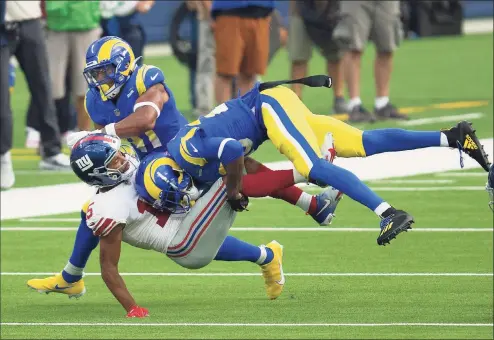  ?? Kyusung Gong / Associated Press ?? Los Angeles Rams cornerback Jalen Ramsey (20), right, tackles New York Giants wide receiver Golden Tate during Sunday’s game in Inglewood, Calif.