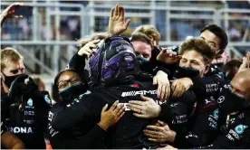  ??  ?? Lewis Hamilton embraces his Mercedes team after sealing a stunning win at the Bahrain Grand Prix. Photograph: Dan Istitene/Formula 1/Getty Images