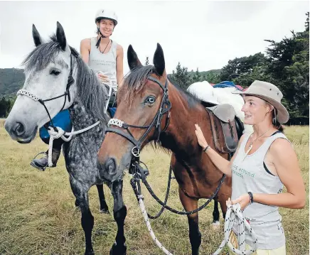  ?? Photo: MAARTEN HOLL/FAIRFAX NZ ?? Horsing around: Larissa Mueller, 27, with Sprite, left, and Kendall Waugh, 24, with China, are two months into a two-year journey trekking New Zealand’s coastline for a youth charity.