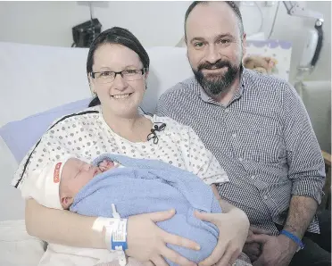  ?? NICK PROCAYLO/PNG ?? Dana and Peter Harlos pose with their baby, Montgomery, who was born right at midnight on New Year’s Day at B.C. Women’s Hospital in Vancouver.