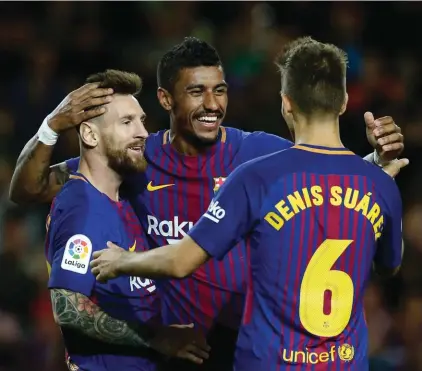  ??  ?? FC Barcelona's Lionel Messi, left, celebrates after scoring with his teammate Paulinho, center, and Denis Suarez during the Spanish La Liga match between FC Barcelona and Eibar at the Camp Nou stadium in Barcelona, Spain, last Tuesday