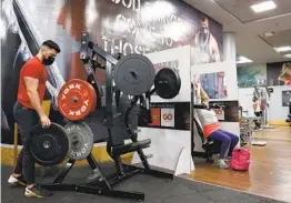  ?? JACK GUEZ AFP VIA GETTY IMAGES ?? People work out at a gym in the Israeli coastal city of Netanya on Sunday. Gyms and some other facilities are open only to fully vaccinated “green pass” holders.