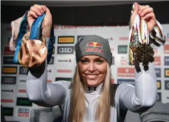  ?? ASSOCIATED PRESS ?? SPOILS OF VICTORY: Lindsey Vonn shows off her medals after the final race of her career yester in Are, Sweden.