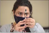  ?? SUBMITTED PHOTO ?? CVS pharmacist Gianna Santangelo draws a single dosage of the Pfizer BioNTech COVID-19 vaccine during a clinic in East Goshen Township.