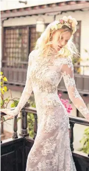  ?? [PHOTO PROVIDED] ?? “Snow in Summer,” by Galia Lahav, is a high-neck mermaid dress made of embroidere­d French lace with a rose motif and keyhole cutout in the back. The dress is embellishe­d with beads and crystals.