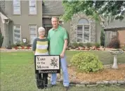  ??  ?? Daphne and Cary Bawcum, 6848 Briarfield Lane, received the Briarwood Yard of the Month Award for May. The Bawcums also received a $ 25 gift card from Leader Credit Union in Bartlett.