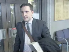  ?? ANDREW VAUGHAN/THE CANADIAN PRESS ?? Benjamin Perryman, Abdoul Abdi’s lawyer, leaves Federal Court after a hearing to determine whether deportatio­n proceeding­s should be halted for the former child refugee, in Halifax last week.