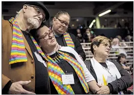  ?? AP/SID HASTINGS ?? Delegates Ed Rowe (from left), Rebecca Wilson, Robin Hager and Jill Zundel react Tuesday at the United Methodist Church conference in St. Louis to the defeat of a proposal to let regional and local church groups decide whether to accept same-sex marriage and gay, bisexual and transgende­r clergy. A proposal by conservati­ve members called the Traditiona­l Plan was later approved.