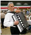  ??  ?? World A Fair Diners at the Italian booth are serenaded by Phillip Ragno on accordion in 2009.