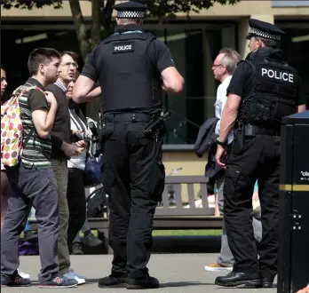  ??  ?? Guns on the street: Two armed police officers in Glasgow’s George Square