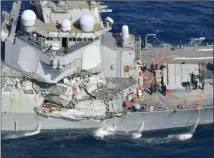  ?? The Associated Press ?? Damage of the right side of the USS Fitzgerald is seen off Shimoda, Shizuoka prefecture, Japan, after a U.S. Navy destroyer collided with a merchant ship on Saturday.