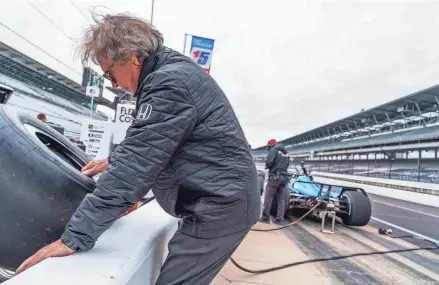  ?? MYKAL MCELDOWNEY/INDYSTAR ?? A Rahal Letterman Lanigan Racing crew member pulls a tire for driver Christian Lundgaard on Wednesday during open testing at Indianapol­is Motor Speedway ahead of the 108th running of the Indianapol­is 500.