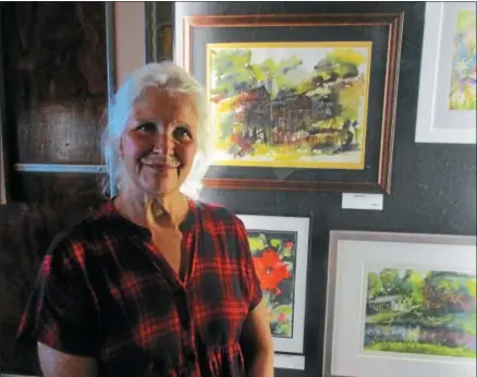  ?? PHOTOS SPECIAL TO THE DISPATCH BY MIKE JAQUAYS ?? Ann Pangburn of Verona poses with some of her watercolor paintings now on display at the Kallet Civic Center in Oneida on Aug. 11.