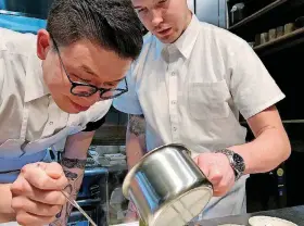  ?? [PHOTO BY DAVE CATHEY, THE OKLAHOMAN] ?? Chefs Paul Wang, left, and Jeremy Wolfe put the finishing touches on a dish during dinner service at the Oklahoma City’s Nonesuch, an ambitious new dining concept that serves eight- and 12-course tasting menus four nights a week.