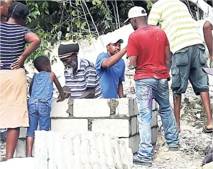  ?? PHOTO BY LEON JACKSON ?? Gravedigge­rs prepare the final resting place for Lacelles Smith in Reserve Cemetery, Trelawny.