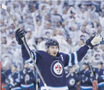  ??  ?? Jets forward Mark Scheifele celebrates his goal against the Wild during the second period of Game 1 in Winnipeg on Wednesday.