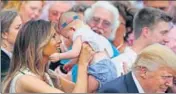  ?? REUTERS ?? Melania Trump holds a baby at a White House event.