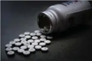  ?? U.S. AIR FORCE PHOTO ILLUSTRATI­ON/TECH. SGT. MARK R. W. ORDERSWOEM­PNER ?? Prescripti­on pain pills are seen dumped out on a table at Grissom Air Reserve Base, Ind.