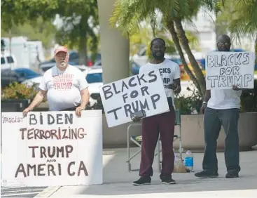  ?? WILFREDO LEE/AP ?? Supporters of Donald Trump stand outside the federal courthouse Thursday in West Palm Beach, Florida.