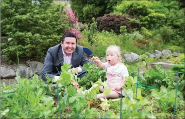  ?? Picture Darragh Kane ?? Jonathan Healy, Presenter with Newstalk and Red FM, gets stuck in to planting seeds with Ciara-Jane O’Sullivan (aged two) from Blarney at the launch of Cope Foundation’s Flowers of Hope campaign at Beech Hill Garden Centre in Montenotte. The...