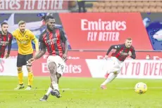  ?? - AFP photo ?? AC Milan’s Ivorian midfielder Franck Kessie shoots to score a last minute penalty against Udinese at the San Siro stadium in Milan.