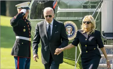  ?? ANDREW HARNIK-ASSOCIATED PRESS ?? President Joe Biden and first lady Jill Biden arrive on the South Lawn of the White House in Washington after returning from Wilmington, Del.