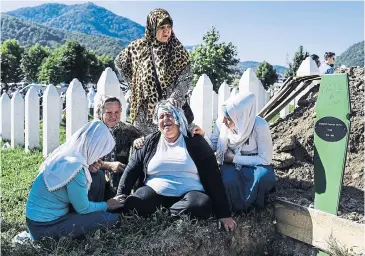  ??  ?? STILL RAW: A Bosnian woman mourns her brother at yesterday’s 20th anniversar­y of the Srebrenica massacre.